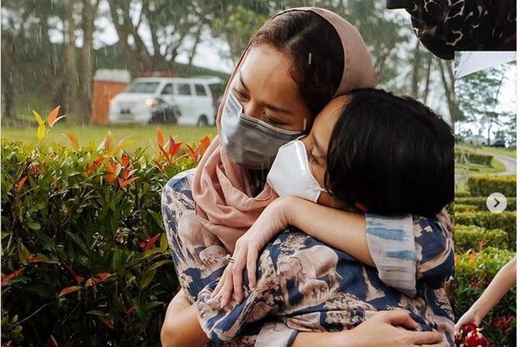 Penyanyi Bunga Citra Lestari dan putranya, Noah Sinclair saat mengunjungi makam Ashraf Sinclair, Kamis (18/2/2021). 